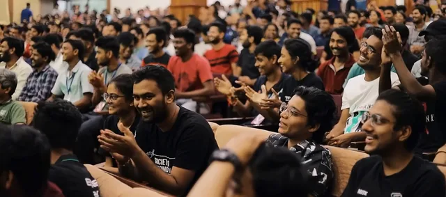 Audience laughing and applauding at an event