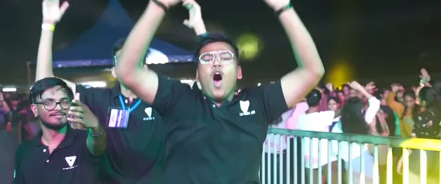 Students cheering with arms raised