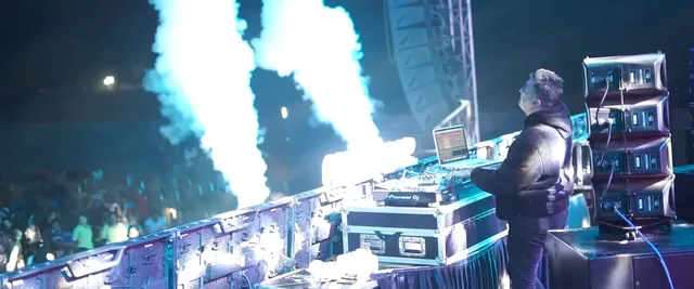 DJ performing as CO2 jets blast on stage