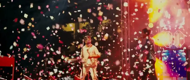 Confetti falling over a performer on the main stage